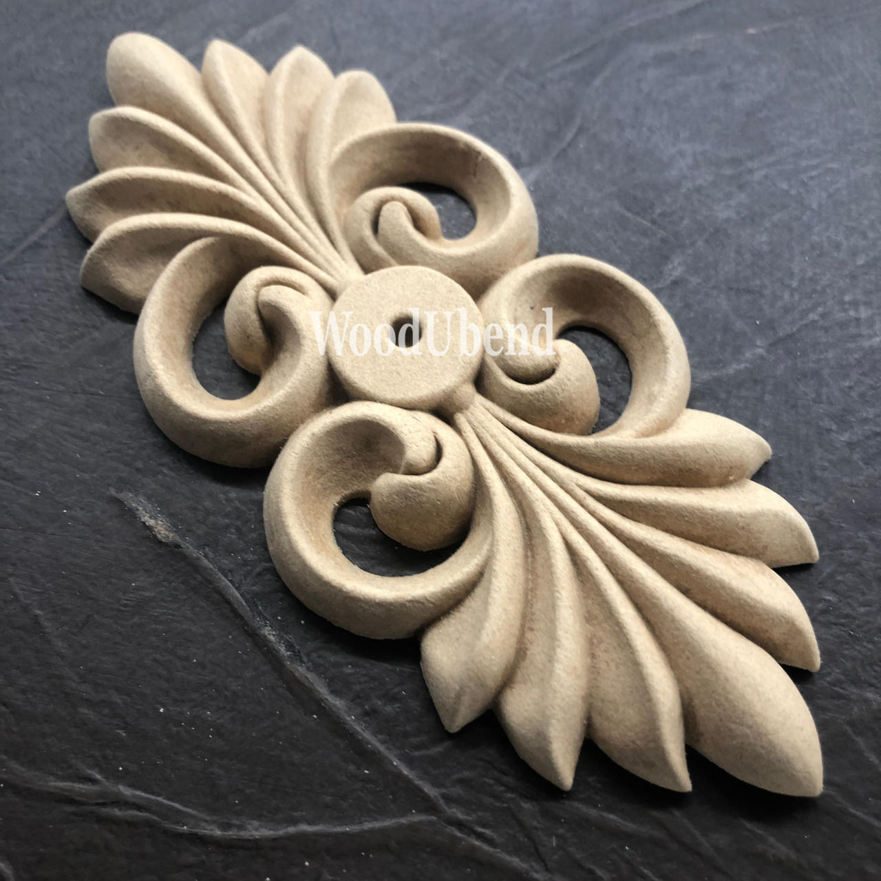 WoodUBend Applique #X1008 is the perfect mouldable embellishment for any project!
Image of a single Applique #X1008 staged on a black crinkled background.