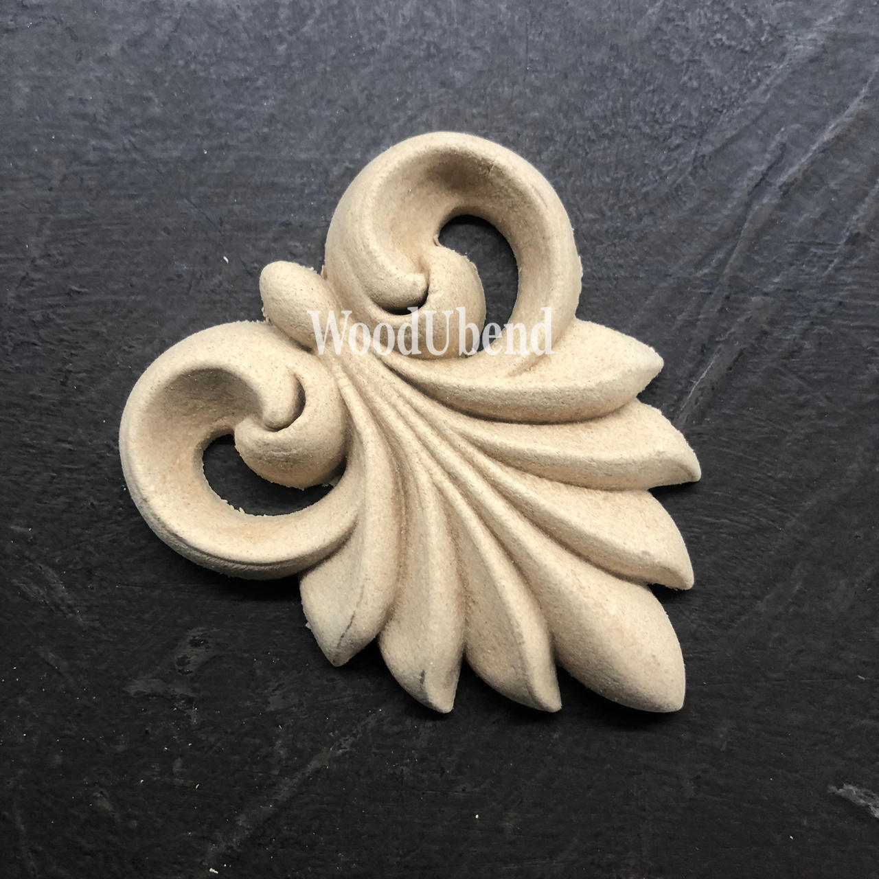 WoodUBend Applique #X1009 is the perfect mouldable embellishment for any project!
Image of Applique #X1009 staged flat on a black crinkled background.