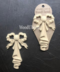 WoodUBend Bow Applique #X1012 (set of 2) is the perfect mouldable embellishment for any project!
This is a set of Wood-u-Bend bows.  The bows look wavy and there's a folded "linen" hanging down from the center of the bow.  The entire piece is a beige color.  One is out of the packaging and the other is still in the packaging.  They are both on top of crinkled,, black leather.