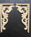 WoodUBend Corner Applique #2160 set of 2
There are two, wood-u-bend corner pieces.  They are placed side-by-side, facing each other.  There is a 90 degree frame around the Victorian curved and embellished piece. They are resting on black leather that fills the picture from edge to edge.