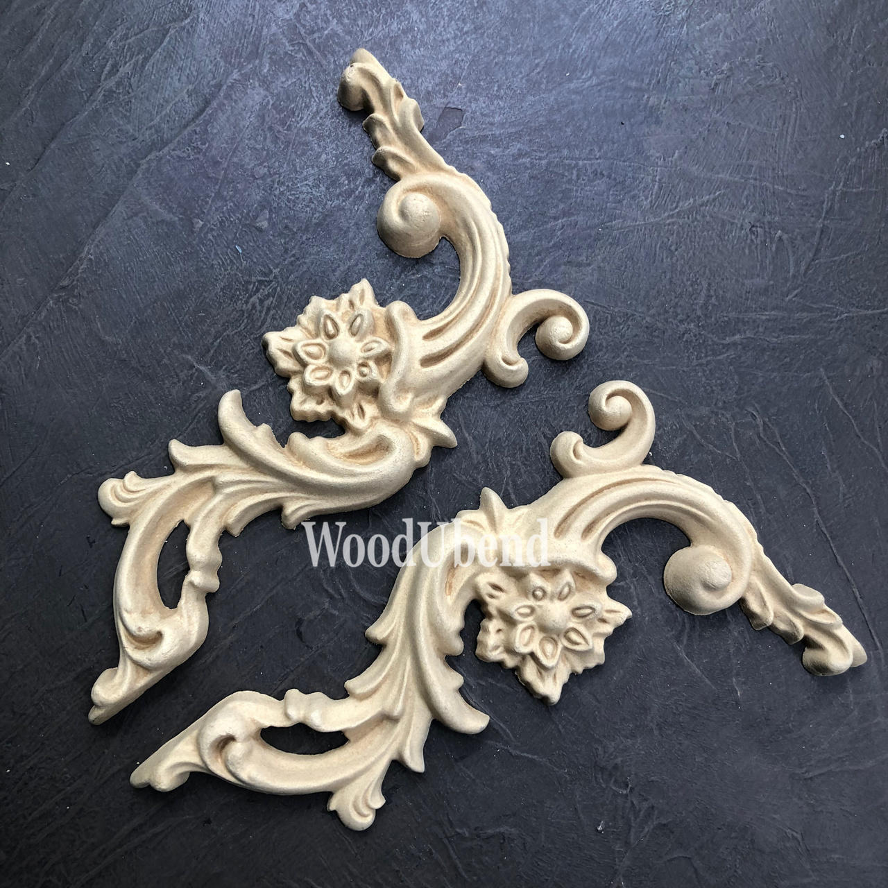 WoodUBend Corner Applique #6025 (set of 2) is the perfect mouldable embellishment for any project!
There are two corner woo-u-bend moldings resting on black leather.  They are both out of the packaging.  They are facing away from each other.  They would be perfect for any DIY furniture project.