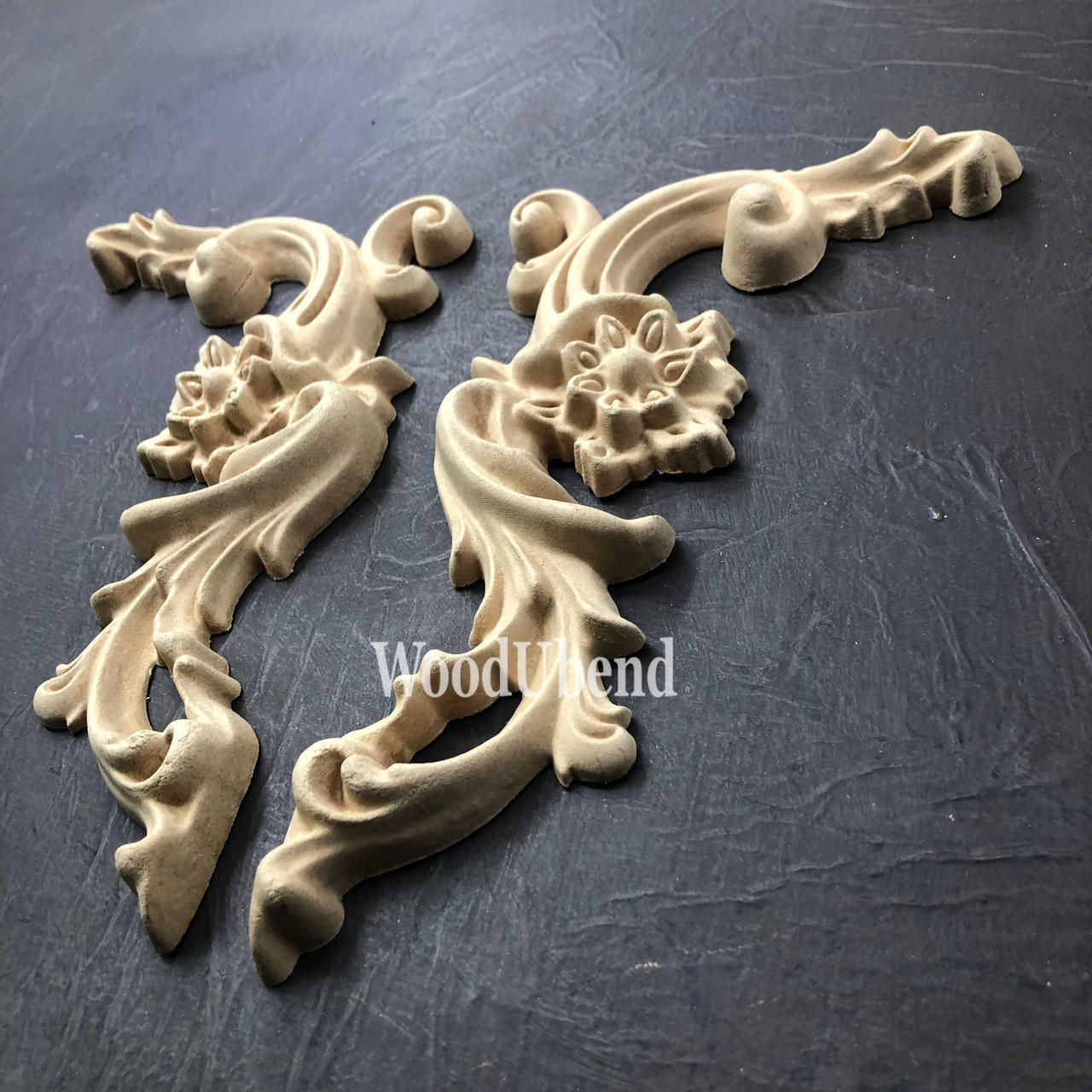 WoodUBend Corner Applique #6025 (set of 2) is the perfect mouldable embellishment for any project!
There are two corner woo-u-bend moldings resting on black leather.  They are both out of the packaging.  They are facing away from each other.  They would be perfect for any DIY furniture project.