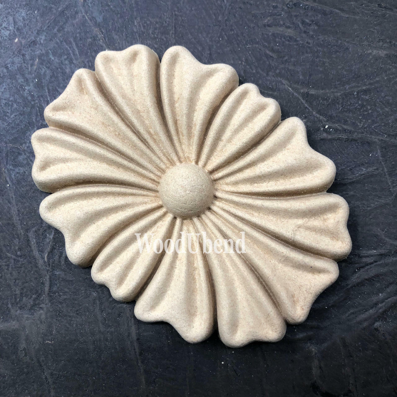 WoodUBend Floral Applique #1333.1 (Set of 2) is the perfect mouldable embellishment for any project!
Image shows one of the Floral Applique #1333.1 Set of 2 out of the packaging, staged on an angle on a black background.