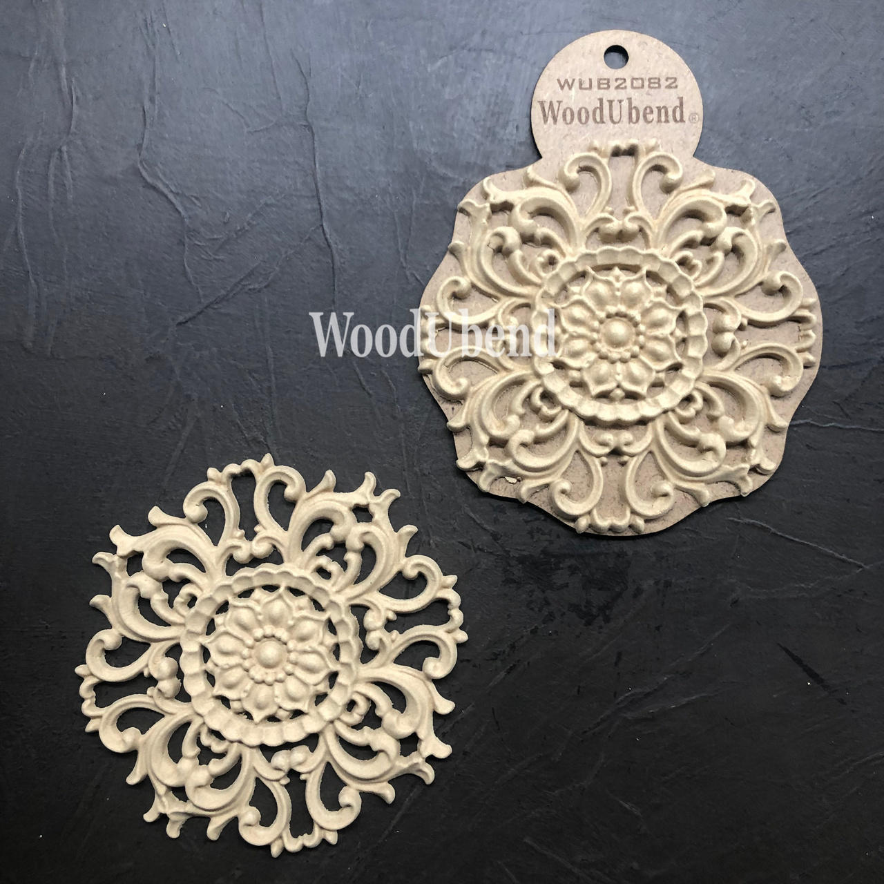WoodUBend Floral Applique #2082 (set of 2) 
Image shows the full set of Floral Applique #2082 one in the packaging while the other one is out. Staged side by side on a black background.