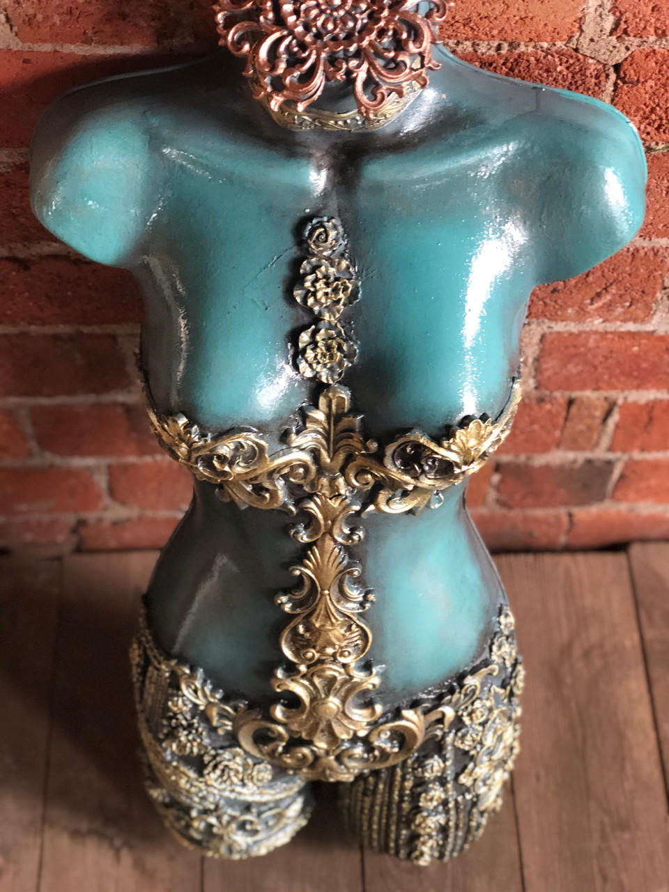 WoodUBend Floral Applique #319 is the perfect mouldable embellishment for any project!
A torso mannequin in blue with applique on the bust and going down the abdomen, the Floral Applique #319 is going down the middle of the bust up the chest.