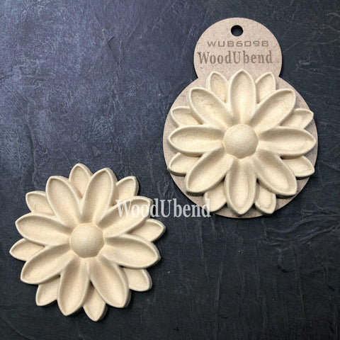 WoodUBend Floral Applique #6098 (Set of 2) is the perfect mouldable embellishment for any project!
An image of the Floral Applique #6098 (Set of 2), one being in the packaging and the other without. Staged on a a black crinkled background.
