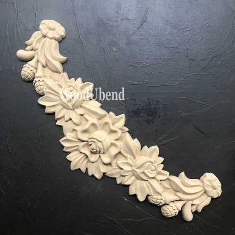 WoodUBend Floral Applique #X1001 is the perfect moldable embellishment for any project!
The Floral Applique #X1001 laid flat on a black crinkle background.