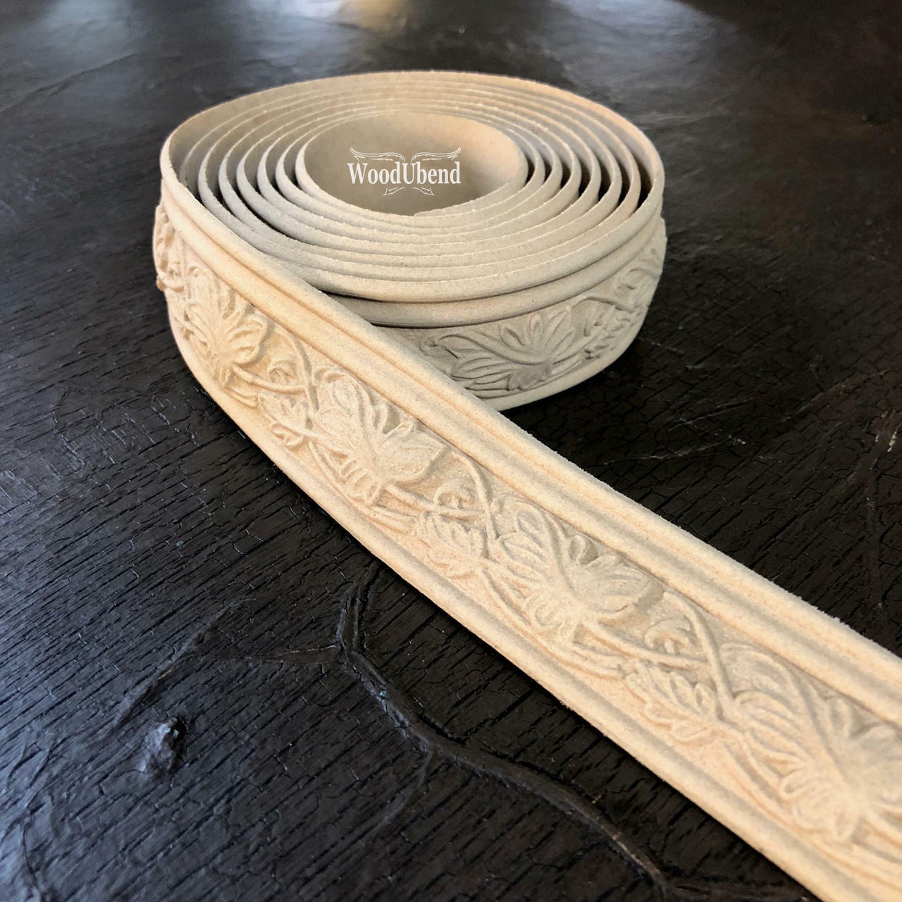 WoodUBend Trim #TR009 is the perfect mouldable embellishment for any project!  A roll of WoodUBend Trim #TR009 lying on a table with 1 end unrolled.