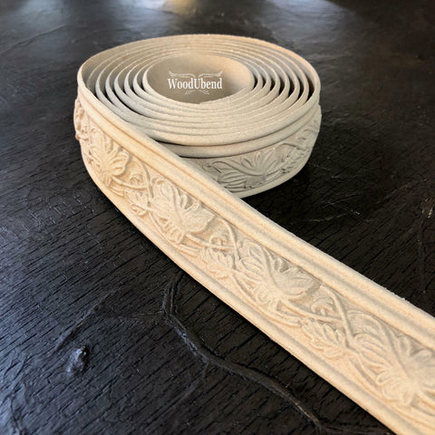 WoodUBend Trim #TR009 is the perfect mouldable embellishment for any project!  A roll of WoodUBend Trim #TR009 lying on a table with 1 end unrolled.