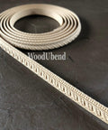 WoodUBend Trim #TR710 (Set of 2).  A roll of WoodUbend sitting on top of a black table, unrolling at one end.