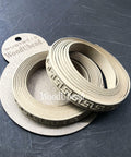 WoodUBend Trim #TR715 (Set of 2) is the perfect mouldable embellishment for any project!  Two rolls of WoodUBend trim sitting on top of a brown piece of paper with WoodUbend WUBTR715 printed at the top; all sitting on a black table.