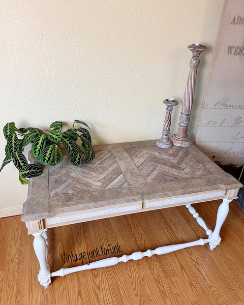 WoodUBend Trim #TR716 (Set of 2) is the perfect mouldable embellishment for any project!  A coffee table with white chalk painted legs and a brown wooden top sitting on a wooden floor in front of a white wall.  The top front of the table has white chalk painted WoodUbend across it.  A green plant and two brown chalk painted candlesticks sit on top of the table.  A white sign with black writing is hanging on the wall to the right of the table.