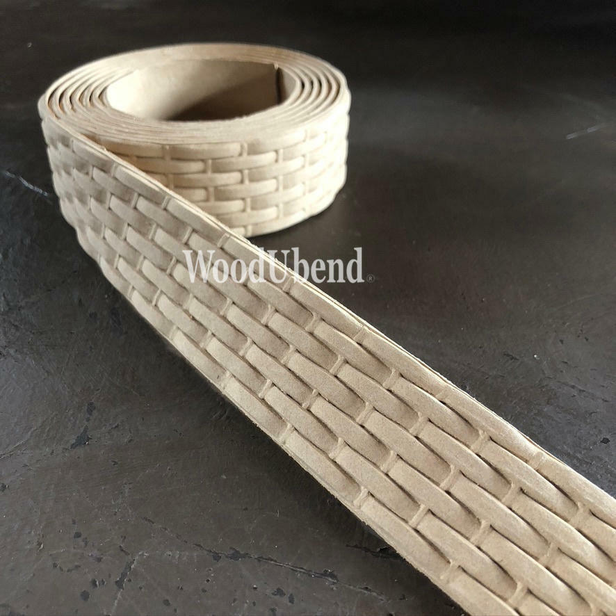 WoodUBend Trim #TR716 (Set of 2) is the perfect mouldable embellishment for any project!  A roll of WoodUbend trim sitting on a brown table, unrolling at one end.